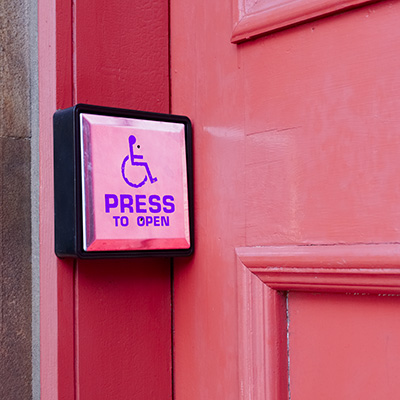 Push button next to the door that it opens
